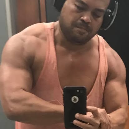 Oliver Maldonado Author Photographed at the Gym Flexing Muscles
