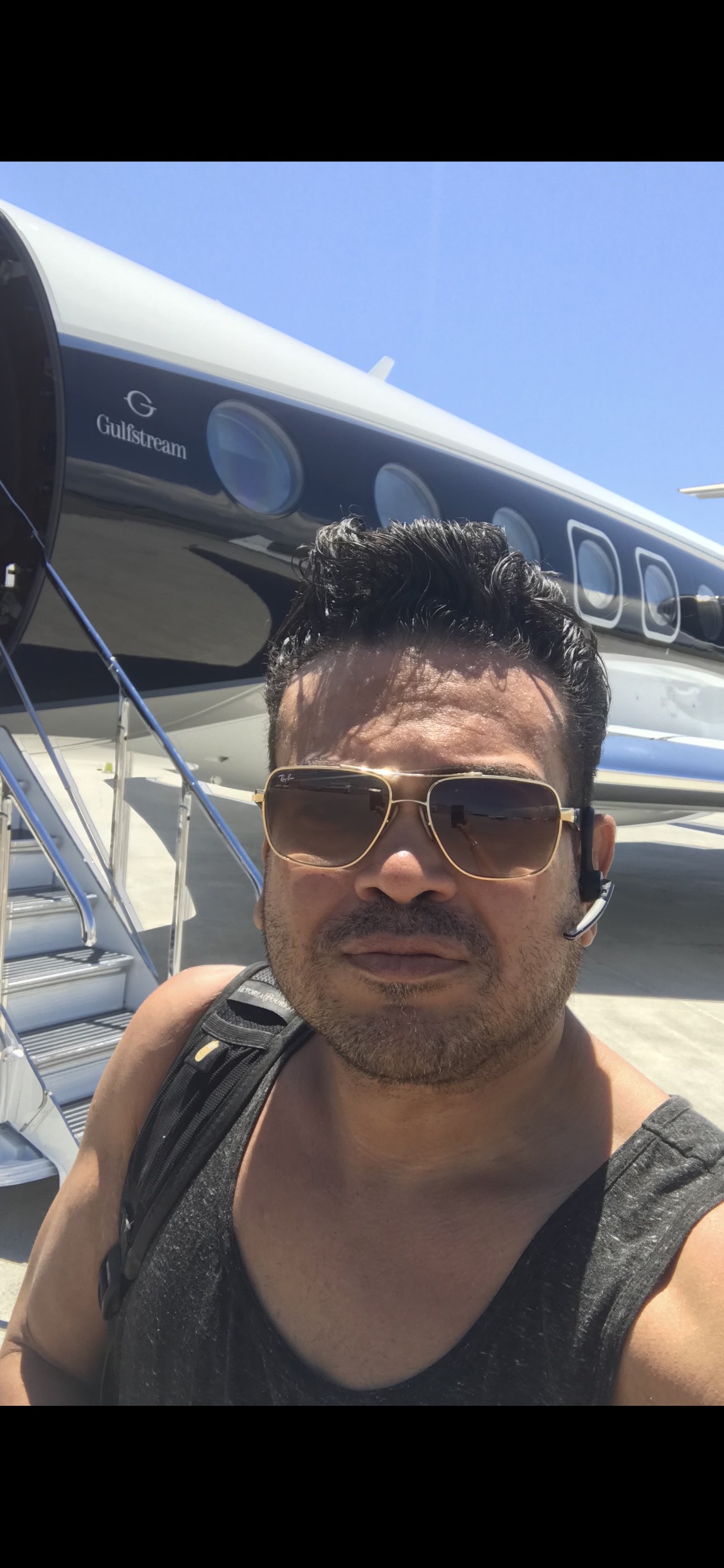 Oliver Maldonado Author Business Consultant & Mortgage Broker Photographed in front of Private Jet